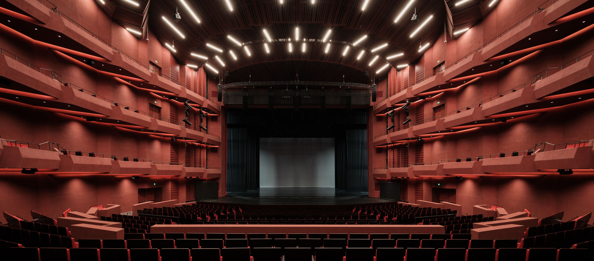Deep-red balconies and seating around the stage of Harmony Hall at Shanghai Grand Opera House