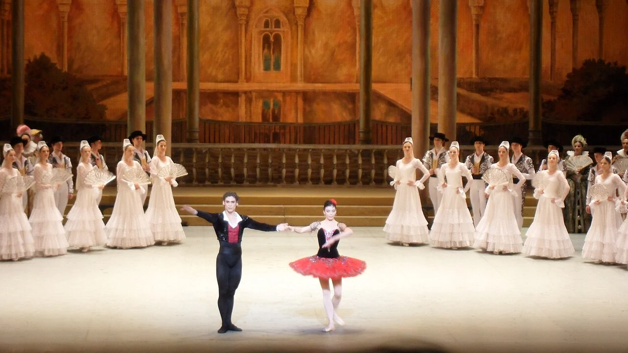 Natalia Osipova and Ivan Vasiliev take a bow in Don Quixote costumes before the Bolshoi ensemble.