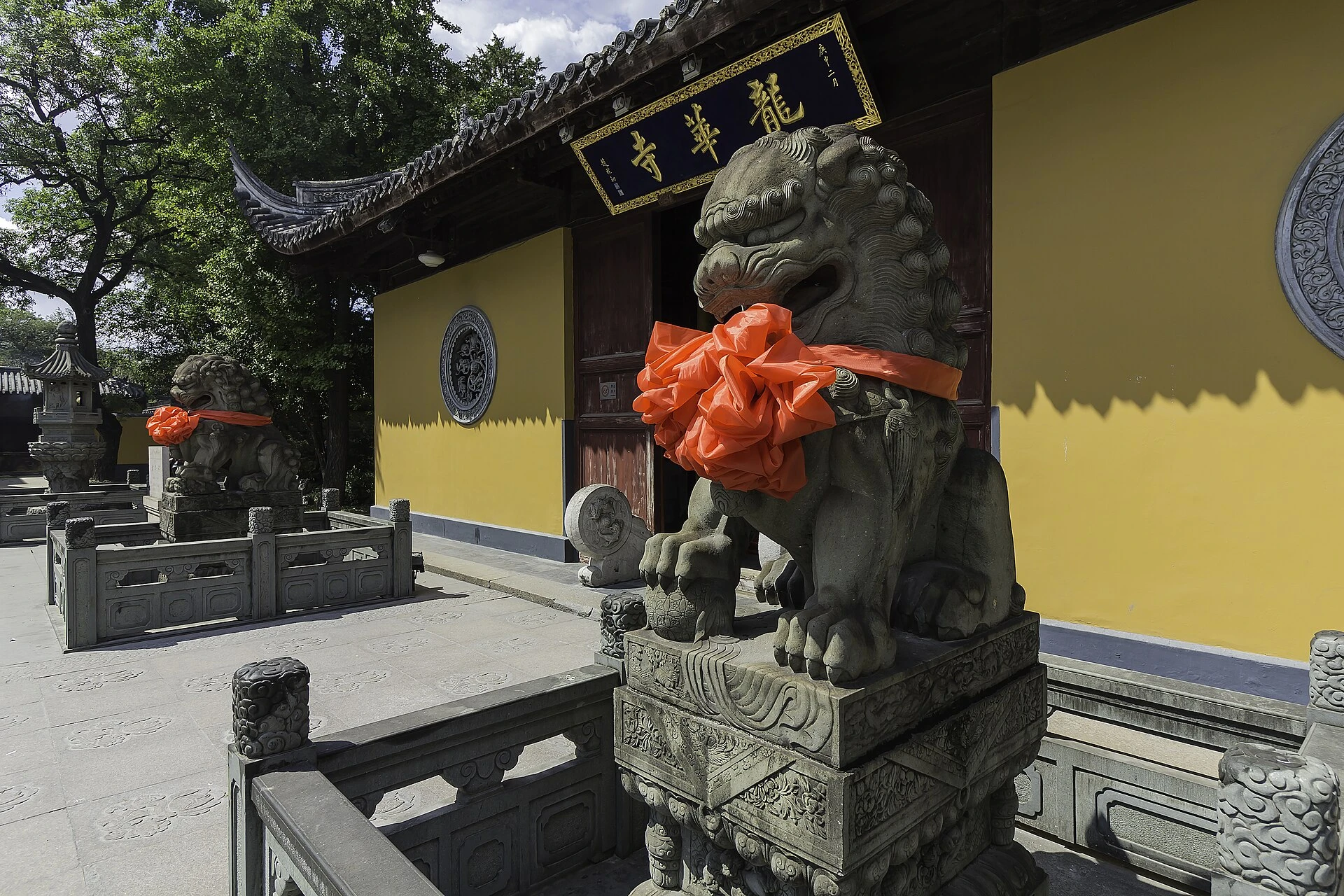 Stone guardian lions outside a hall at Longhua Temple